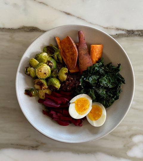 Grain Bowl with Sweet Potatoes, Brussel Sprouts, Marinated Beets, Kale, Quinoa and a Soft Boiled Egg